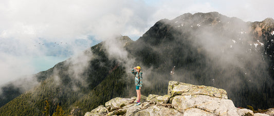 A person stood atop a mountain ridge